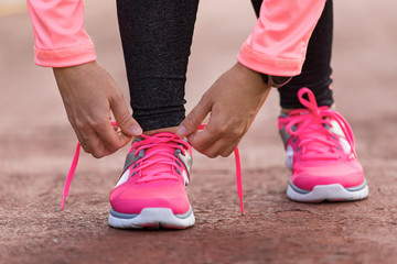 Wall Mural - sport woman tying shoe laces