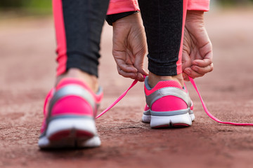 Wall Mural - sport woman tying shoe laces