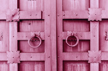 Metal Pink Vintage Textured Door With Rings Door Handles And Metal Details In Form Of Stylized Flowers.