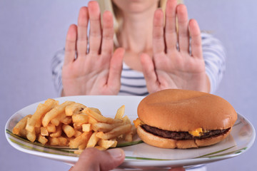 Woman refuses to eat junk food . Healthy eating and active lifestyle concept