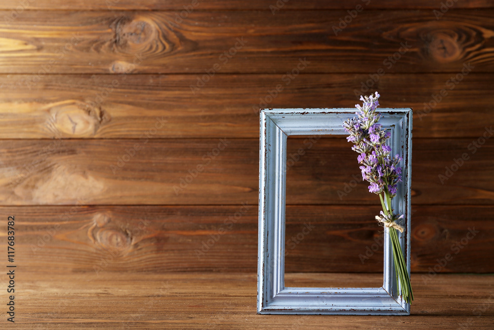 Lavender with frame on wooden background