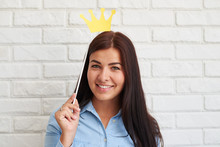 Smiling Woman Holding A Paper Crown On Stick