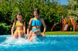 © Iuliia Sokolovska - Kids in swimming pool have fun and splash in water, children on family vacation