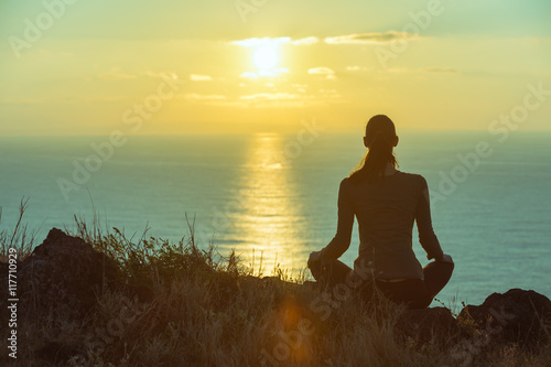 Fotografie, Obraz Female by the sea relaxing watching the sunset.