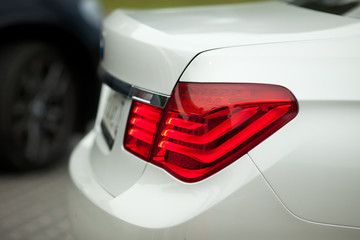 Wall Mural - A closeup of red lights of white BMW