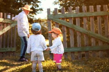 kids walk with grandfather in summer