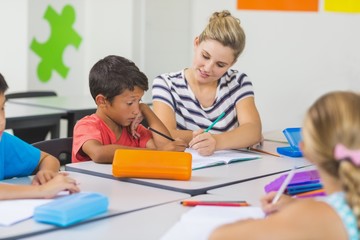 Poster - Teacher helping kids with their homework in classroom