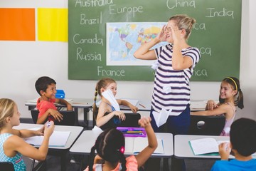 Poster - School kids throwing paper balls on teacher