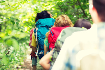 Canvas Print - close up of friends with backpacks hiking