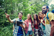 © Syda Productions - happy friends with backpacks and tablet pc hiking