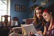© Wavebreak Media - Young couple using digital tablet while sitting at home