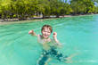 © travelview - young boy enjoys swimming in the ocean