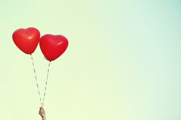 Love heart balloons on sky background