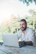 © minastefanovic - Young man at cafe working on laptop