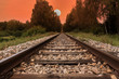 Railway line, trail or track  going through landscape at sunset