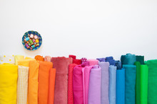 Rolls Of Bright Colored Fabric On A White Background.