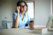 © lenets_tan - Young woman sitting at office table with laptop