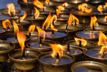 Rows Of Butter Lamps At A Buddhist Monastery.