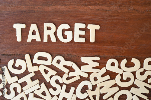 Word Target Made With Block Wooden Letters Next To A Pile Of Other Word Target Made With Block Wooden Letters Next To A Pile Of Other Over The Board Surface Composition