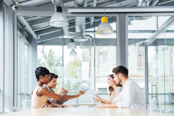 Businesspeople talking and working together in conference room