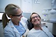© WavebreakMediaMicro - Female dentist interacting with male patient