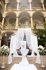 Gorgeous balconies in Italian style hang over the wedding altar