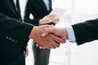© DragonImages - Business people shaking hands after successful deal