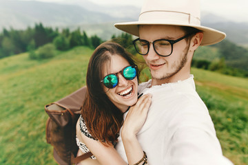 Wall Mural - stylish  hipster couple traveling and smiling and having fun on