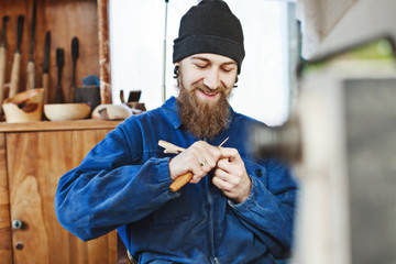 A man working with woodcarving instruments