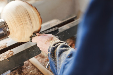 A man working with woodcarving instruments