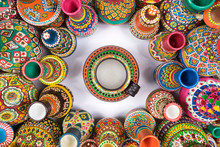 Top View Showing A Composition Of Artistic Painted Handcrafted Pottery Vases Compacted In A Circle Around A Single Vase On White Background