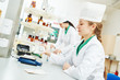 © Kadmy - Female scientific pharmacy worker preparing medicine drug