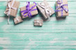 © daffodilred - Many  festive gift boxes with presents on turqoise  wooden backg