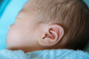 baby ear asia while sleeping covered at the hospital
