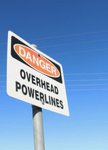 Danger, Overhead Powerlines Warning Sign, With Visible Power Lin