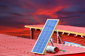 Solar panel on a red roof at Larung gar (Buddhist Academy) in Sichuan and red sky background