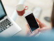 © Myvisuals - Pretty young business woman using mobile phone in startup office