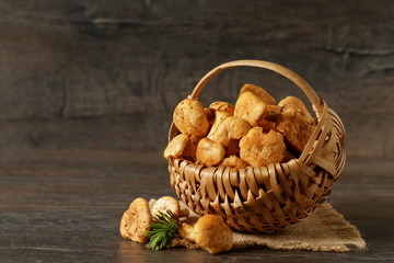 Wall Mural - Vintage basket of chanterelles mushrooms from forest on a wooden planks background