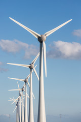 Row of wind turbines and blue sky