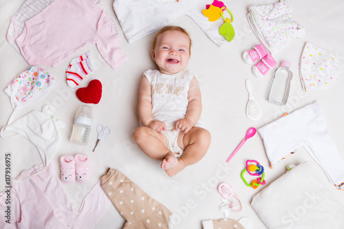 Fotografering Baby on white background with clothing, toiletries, toys and health care accessories