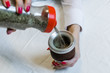 Young woman preparing traditional Argentinian yerba mate tea by putting it into calabash gourd. Selective focus.