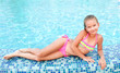 © svetamart - Adorable smiling little girl in swimming pool