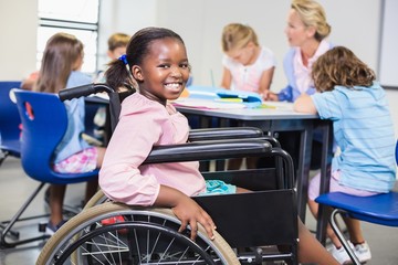 disabled schoolgirl smiling in classroom