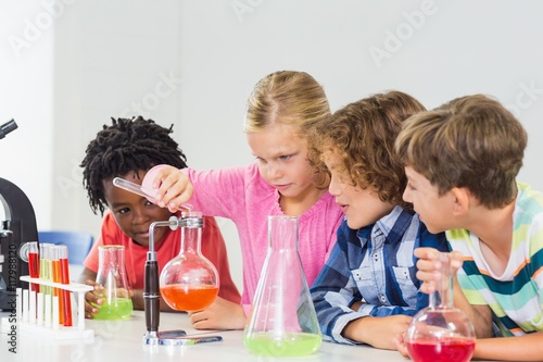 Fotografie, Obraz Kids doing a chemical experiment in laboratory