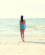 © Syda Productions - young woman in swimsuit walking on beach