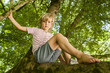 © Westend61 - Portrait of little boy sitting on a tree in the forest