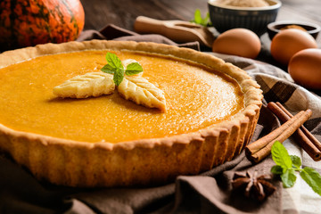 Wall Mural - Traditional American pumpkin pie with cinnamon and mint