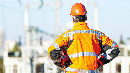 Service engineer standing in front of heat electropower station