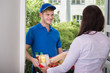 © Andrey Popov - Smiling Young Woman Delivers Groceries