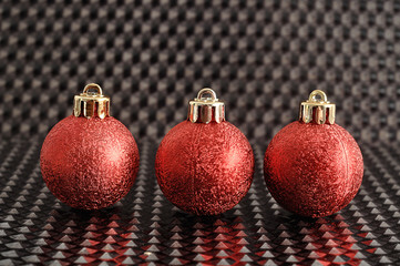 red christmas tree baubles isolated on a black background
